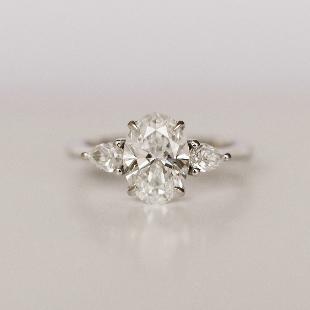 custom oval diamond engagement ring with pear side stones