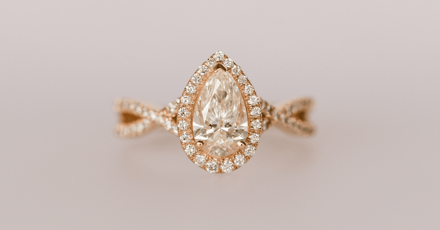 2000s - Rose Gold Diamond Halo Engagement Ring with a Twisted Shank and Pavé Accent Stones set with a Pear Cut Diamond