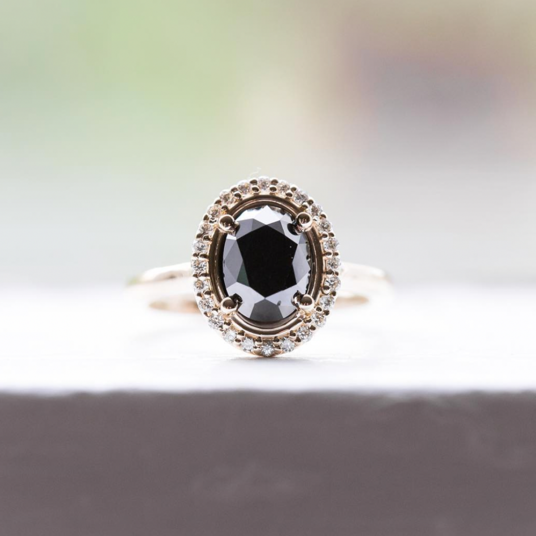 black custom oval diamond engagement ring with halo