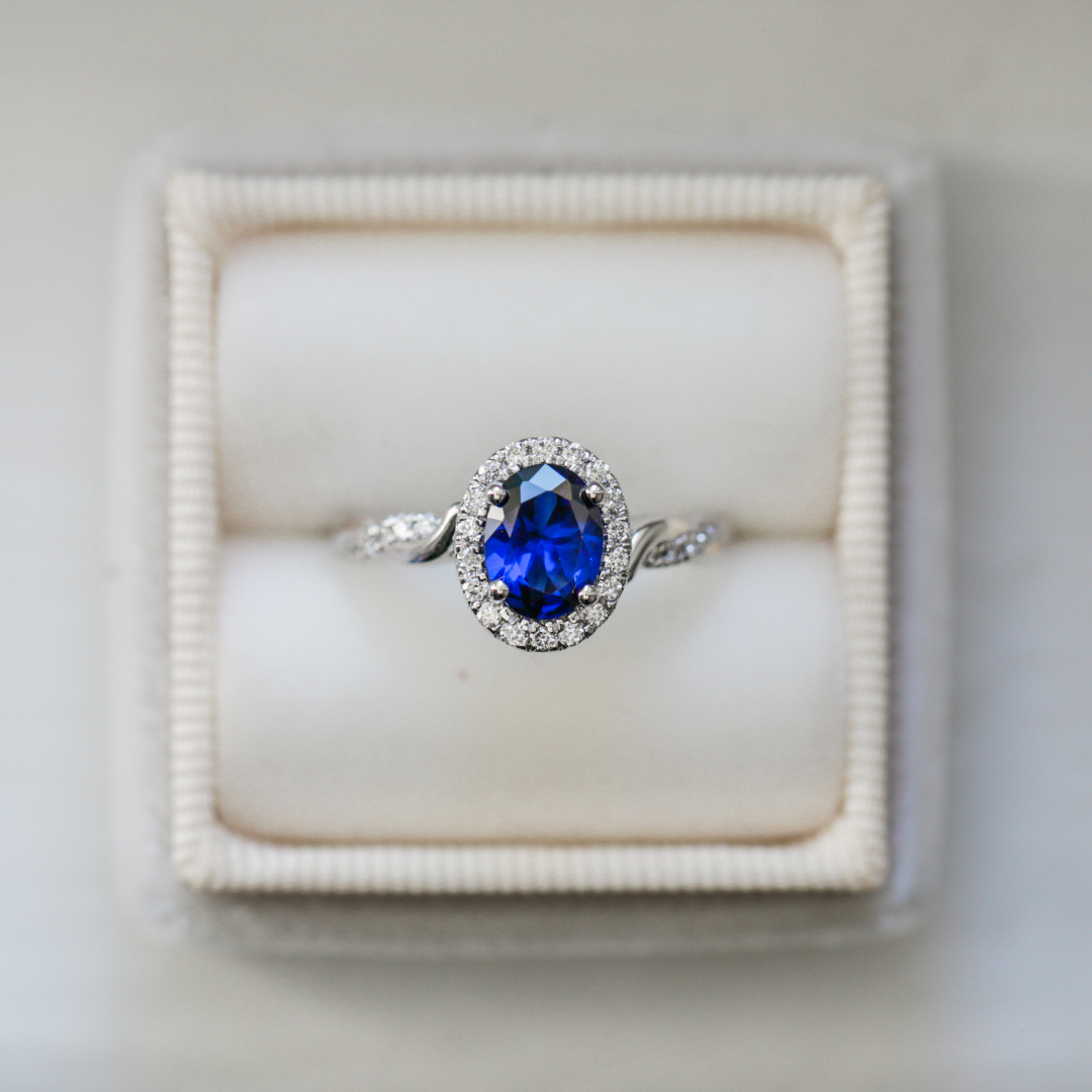 blue sapphire oval engagement ring with diamond halo