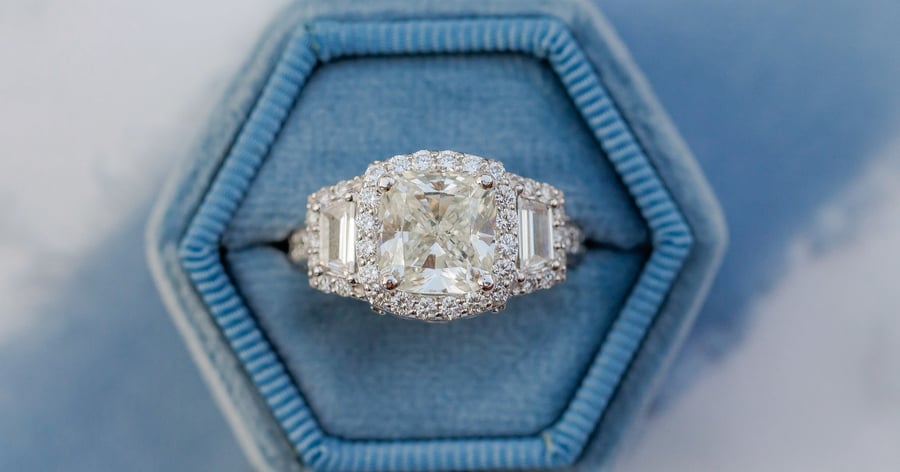 Three Stone Diamond Ring with Halos in a Blue Velvet Ring Box