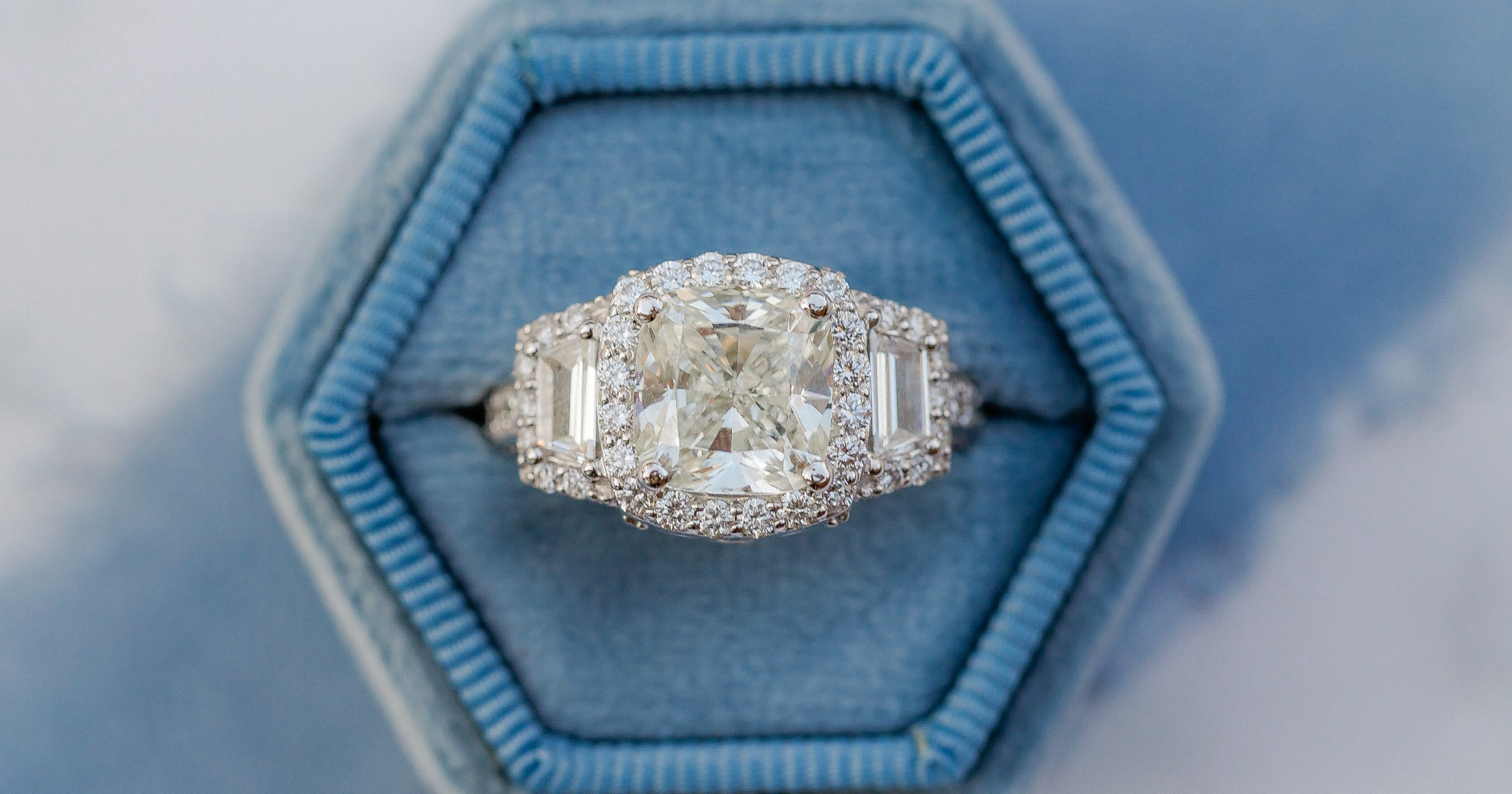 White Gold (or Platinum) Three Stone Diamond Halo Engagement Ring set with a Cushion Cut Diamond