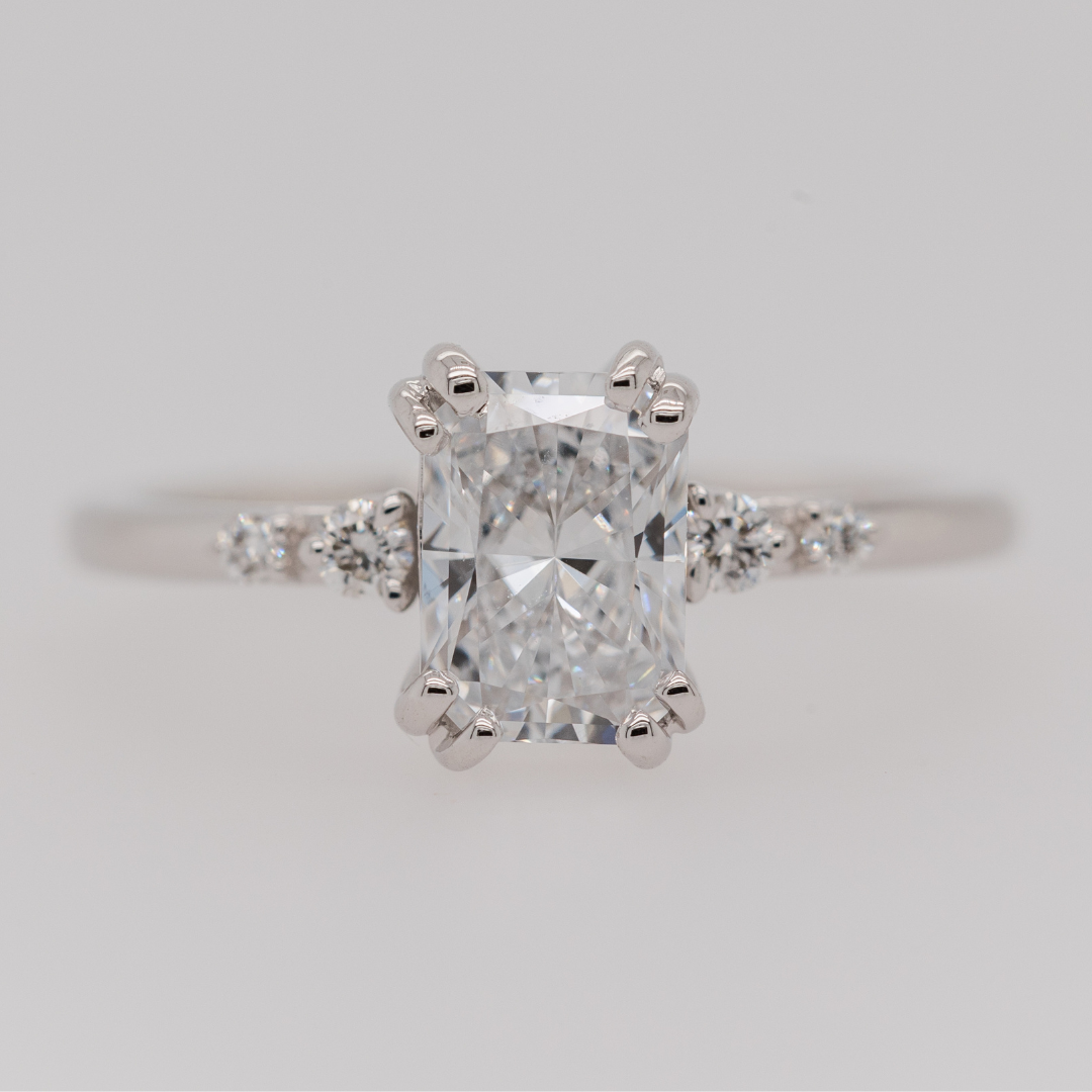 radiant cut diamond engagement ring with double prongs and accented band