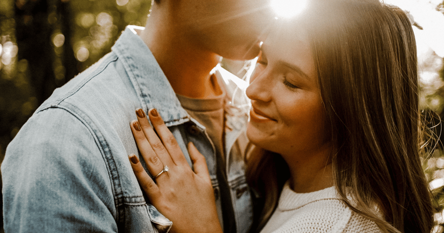 Engaged Couple Showing Off Engagement Ring