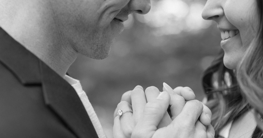 Engaged Couple Smiling and Showing Off Engagement Ring