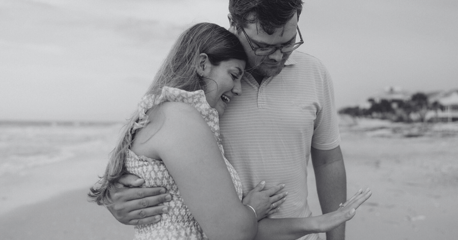 Newly Happy Engaged Couple Looking at Engagement Ring