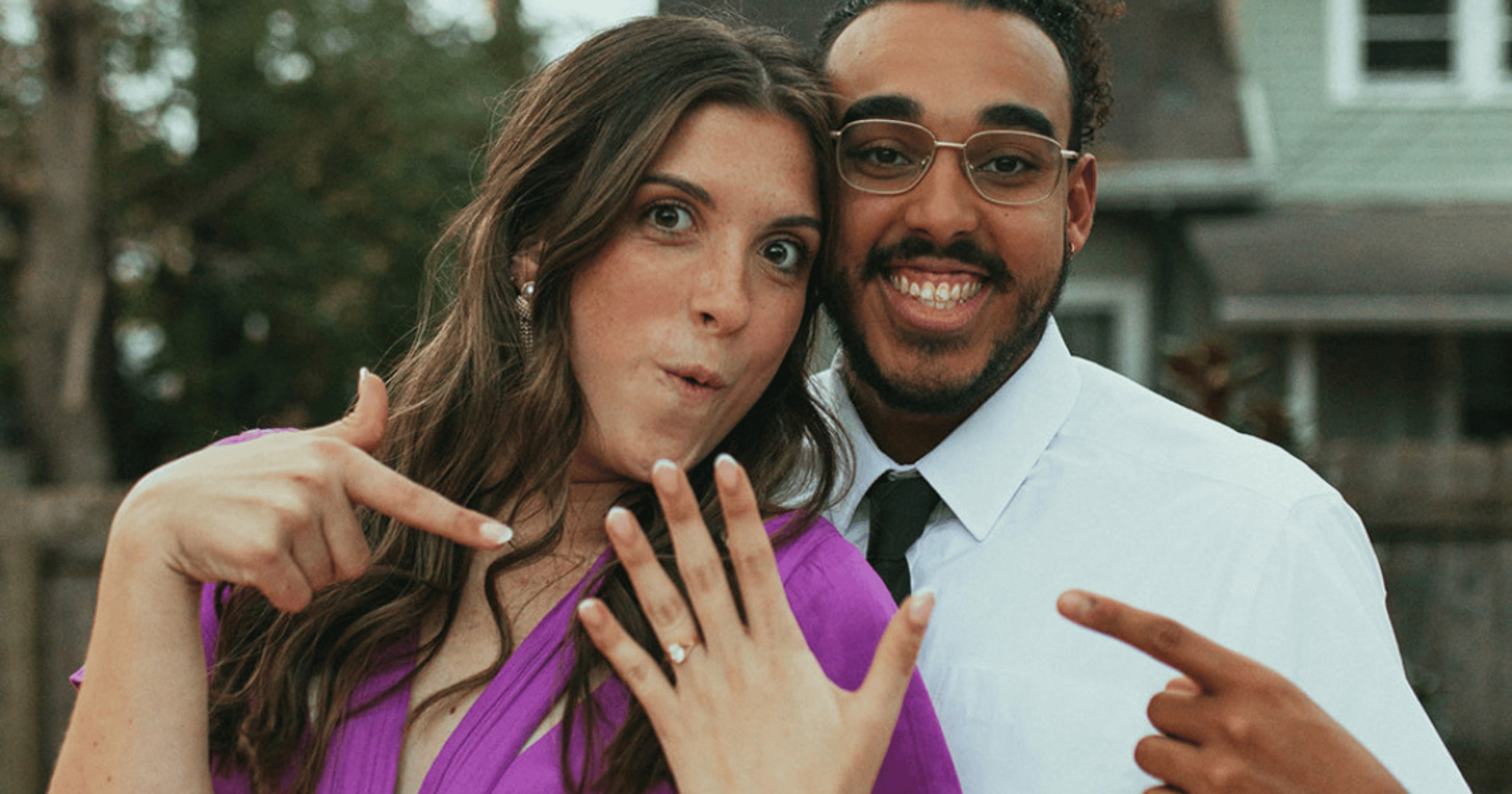 Newly_engaged_couple_excited_showing_off_ring