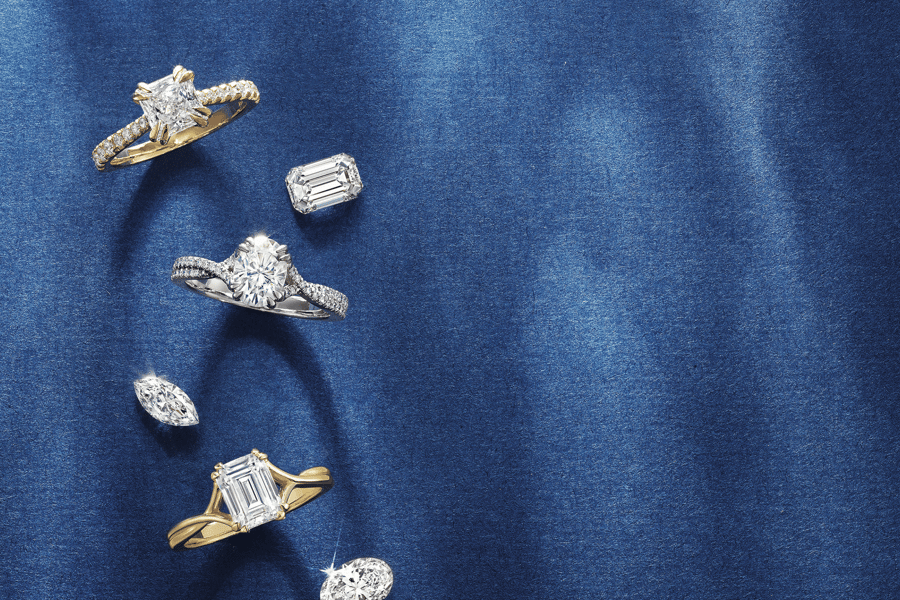 Various_Diamonds_and_Engagement_Rings_with_Blue_Reflective_Background