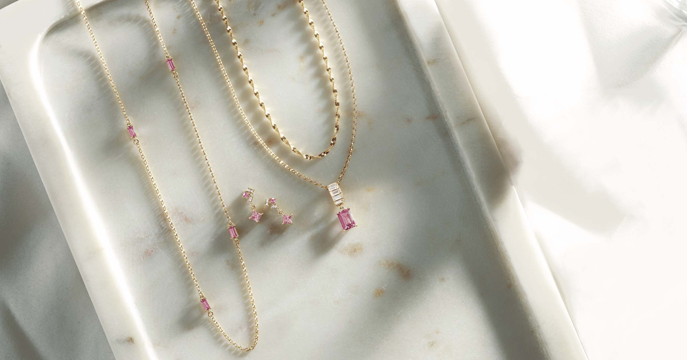Various_Yellow_Gold_Necklaces_and_Earrings_with_Pink_Gemstones