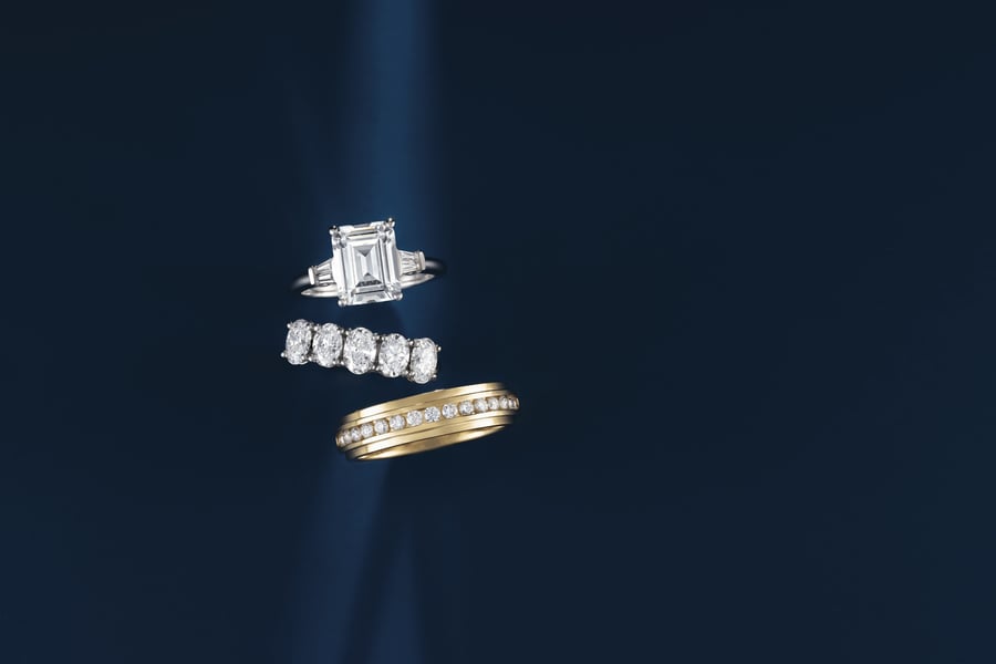 White Gold (or Platinum) Accented Engagement ring set with an Emerald Cut Diamond; White Gold (or Platinum) Five Stone Oval Wedding Band; Mens Yellow Gold Accented Wedding Band