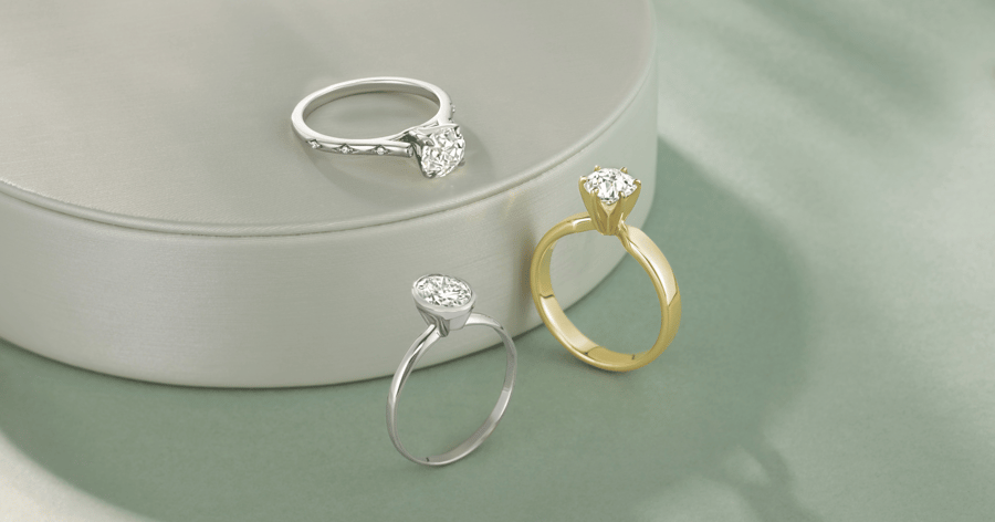 White Gold (or Platinum) Engagement Ring with Accent Stones set with a Round Cut Diamond; White Gold (or Platinum) Engagement Ring Bezel set with an Oval Cut Diamond; Yellow Gold Solitaire Engagement Ring with set with a Round Cut Diamond