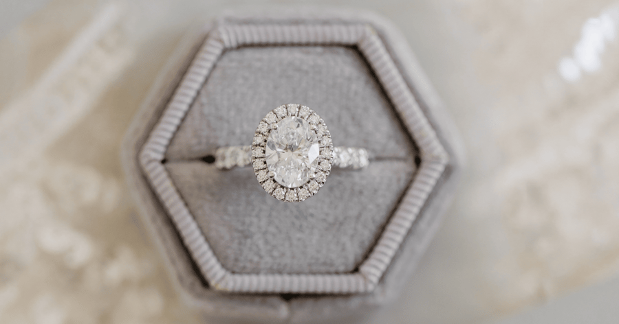 White Gold (or Platinum) with Diamond Halo Engagement Ring with Pavé Accent Stones set with an Oval Cut Diamond