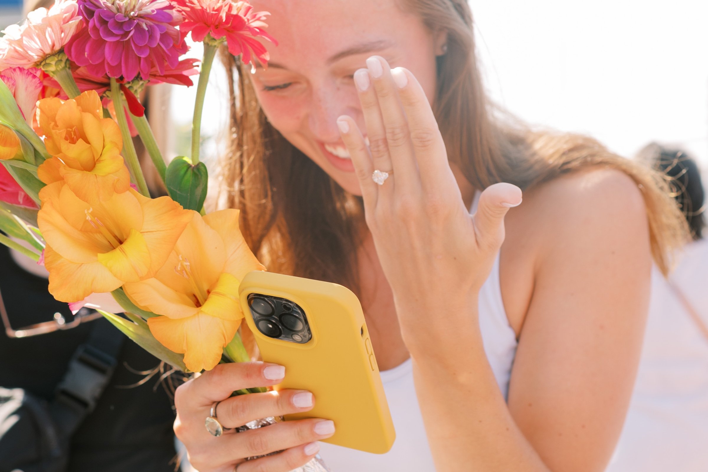 Woman_Showing_Ring_To_Phone
