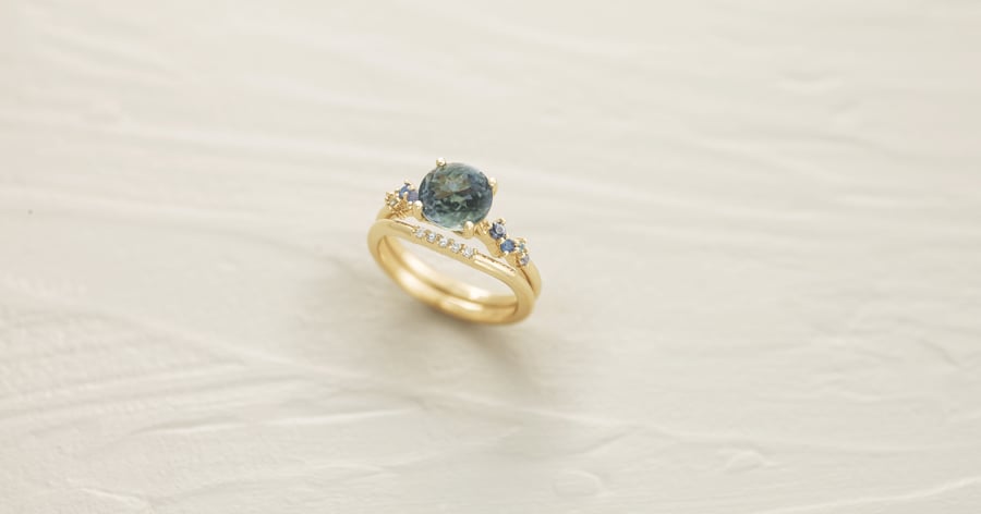 Yellow Gold Accented Engagement Ring set with a Round Gemstone and Matching Accented Wedding Band