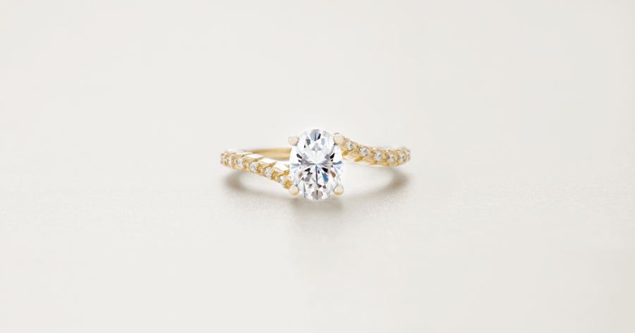 Yellow Gold Bypass Accented Engagement Ring set with an Oval Cut Diamond