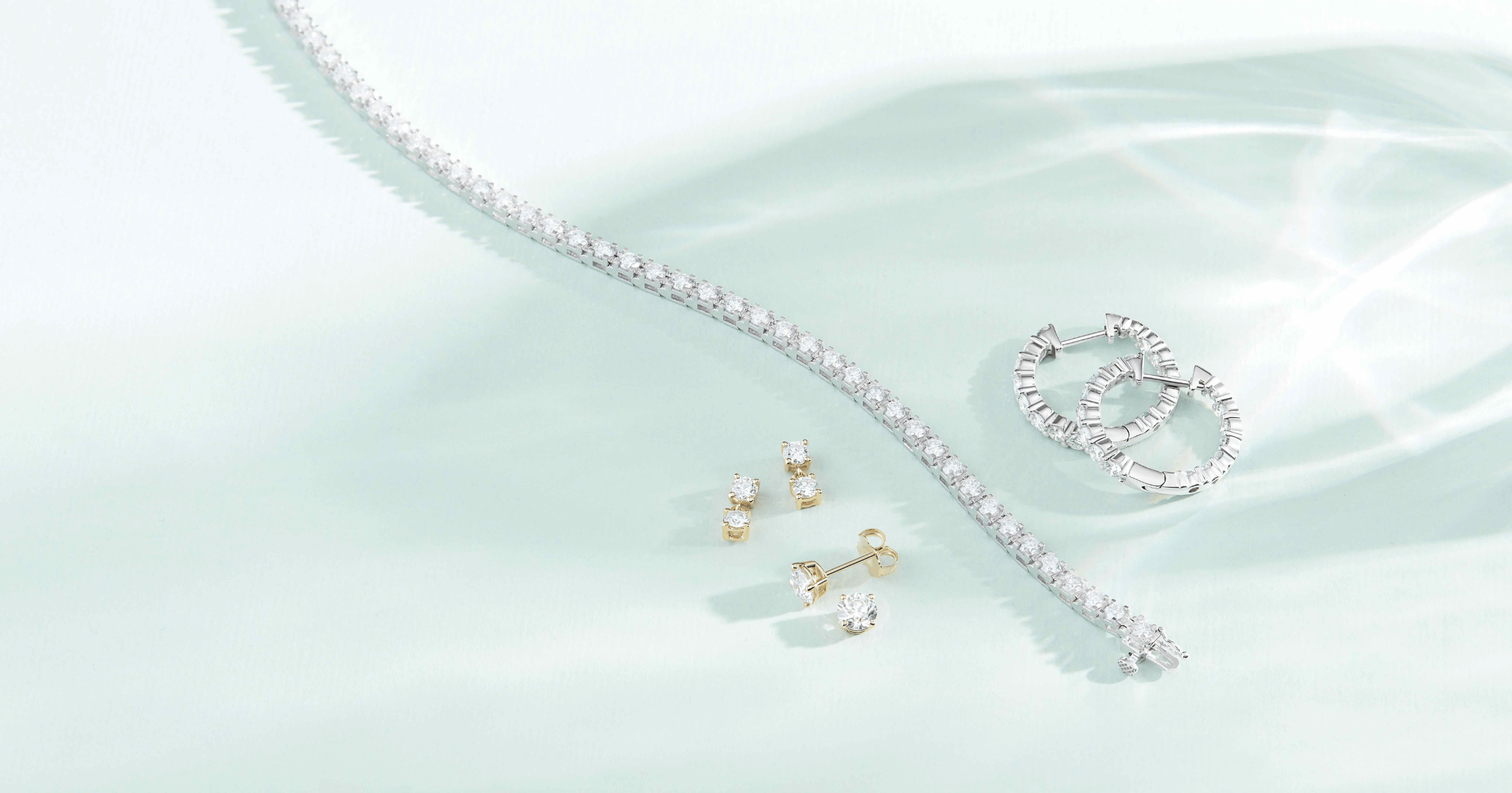 Yellow Gold Diamond Earrings; White Gold (or Platinum) Diamond Tennis Bracelet; White Gold (or Platinum) Diamond Hoops