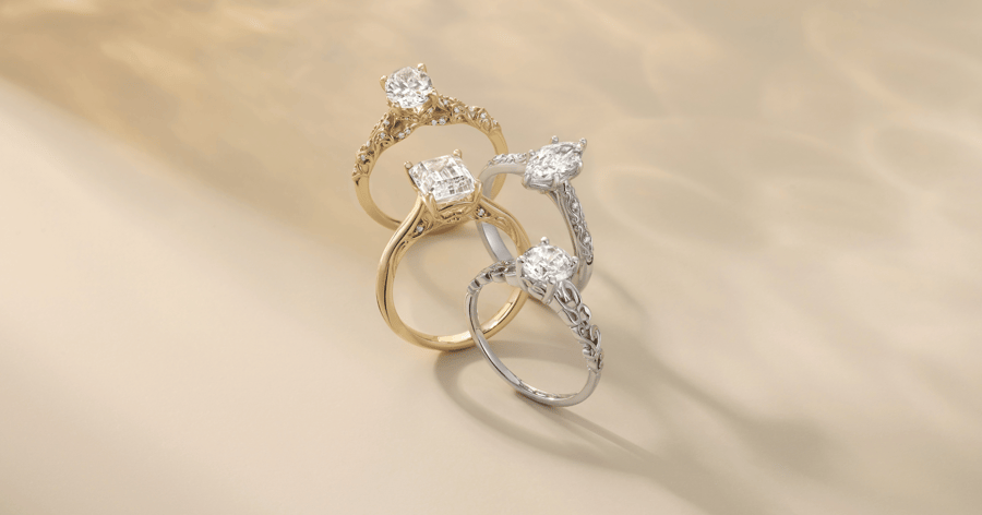 Yellow Gold Engagement Ring with Accent Stones and Detailing set with an Oval Cut Diamond; White Gold (or Platinum) Engagement Ring with Accent Stones and Detailing set with a Marquise Cut Diamond; Yellow Gold Engagement Ring with Accent