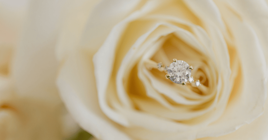 Yellow Gold Engagement Ring with Accent Stones set with a Round Cut Diamond