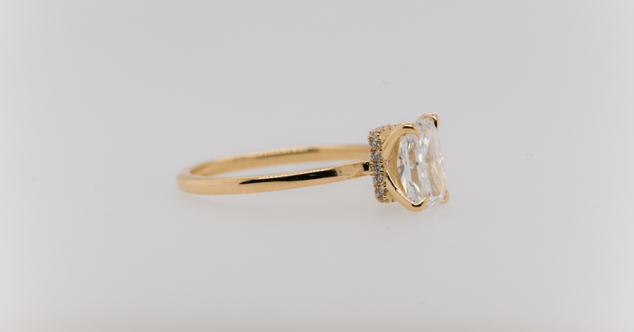 Yellow Gold Hidden Halo Engagement Ring set with a Radiant Cut Diamond