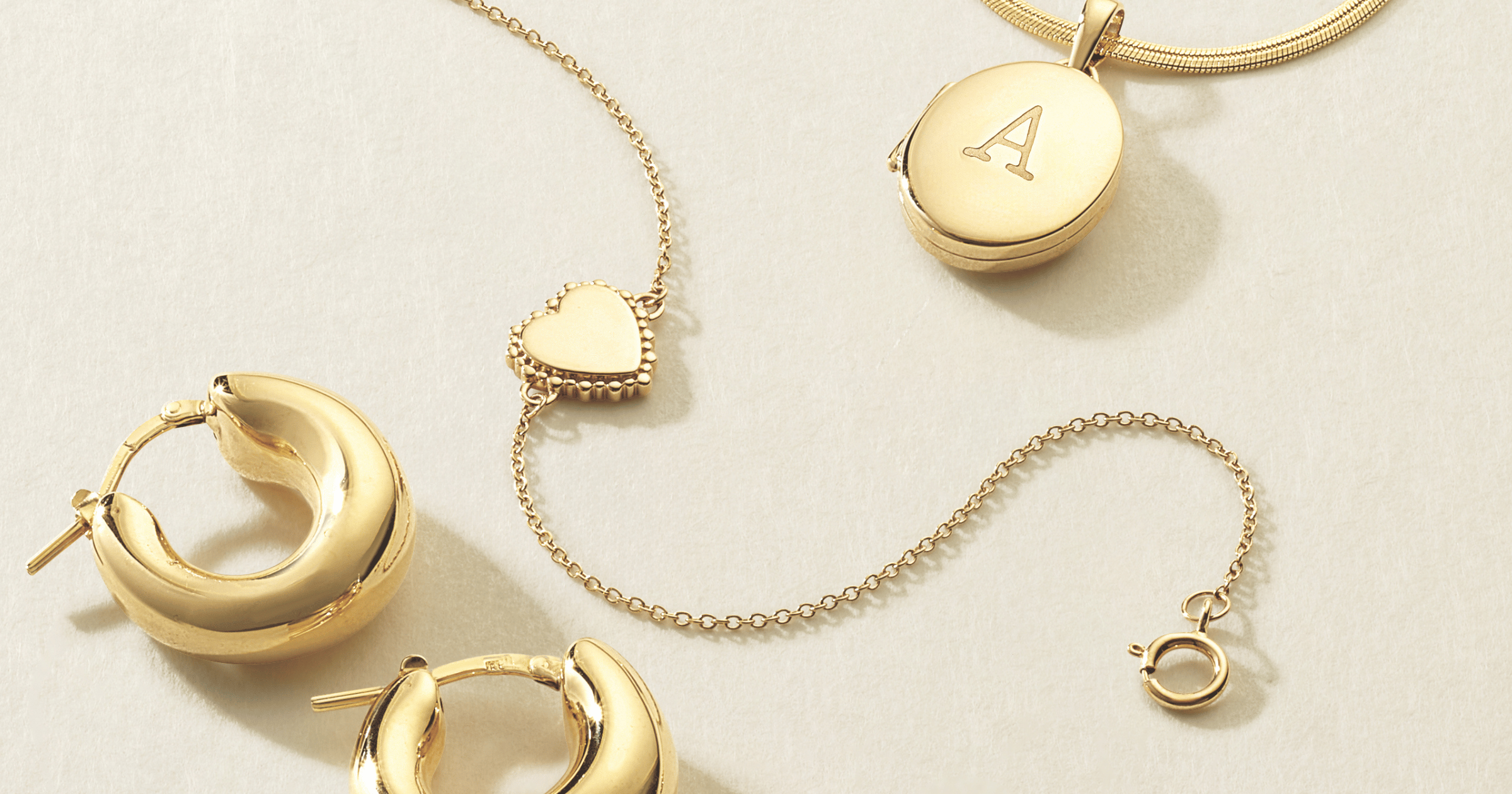 Yellow Gold Hoops, Heart Bracelet, and Initial Locket