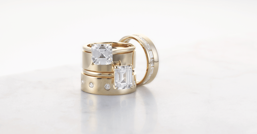 Yellow Gold Solitaire Engagement Ring set with an Asscher and Emerald Cut Diamond; Yellow Gold Wedding Band; Yellow Gold Diamond Accented Wedding Bands set with Round and Baguette Cut Diamonds