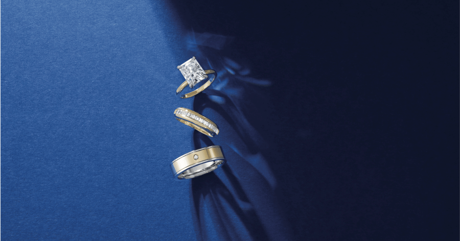 Yellow_Gold_Solitaire_Engagement_Ring_set_with_a_Radiant_Cut_Diamond_shown_with_Complementary_Womens_and_Mens_Accented_Wedding_Bands