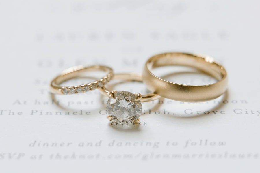 Yellow_Gold_Wedding_Band_with_Diamond_Studded_Yellow_Gold_Band_and_Faithful_Platform_Engagement_Ring_on_Wedding_Invite