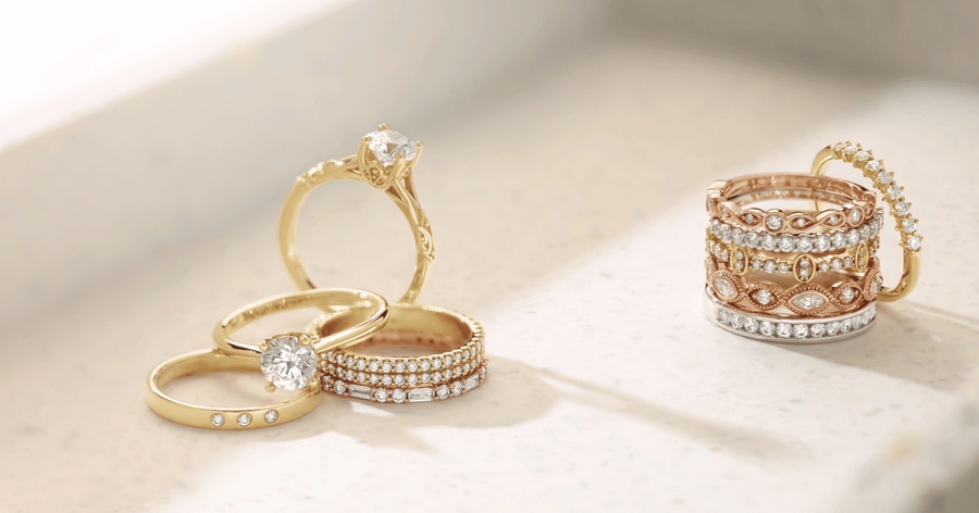 Yellow_gold_accented_and_solitaire_engagement_rings_with_various_accented_diamond_stackable_bands