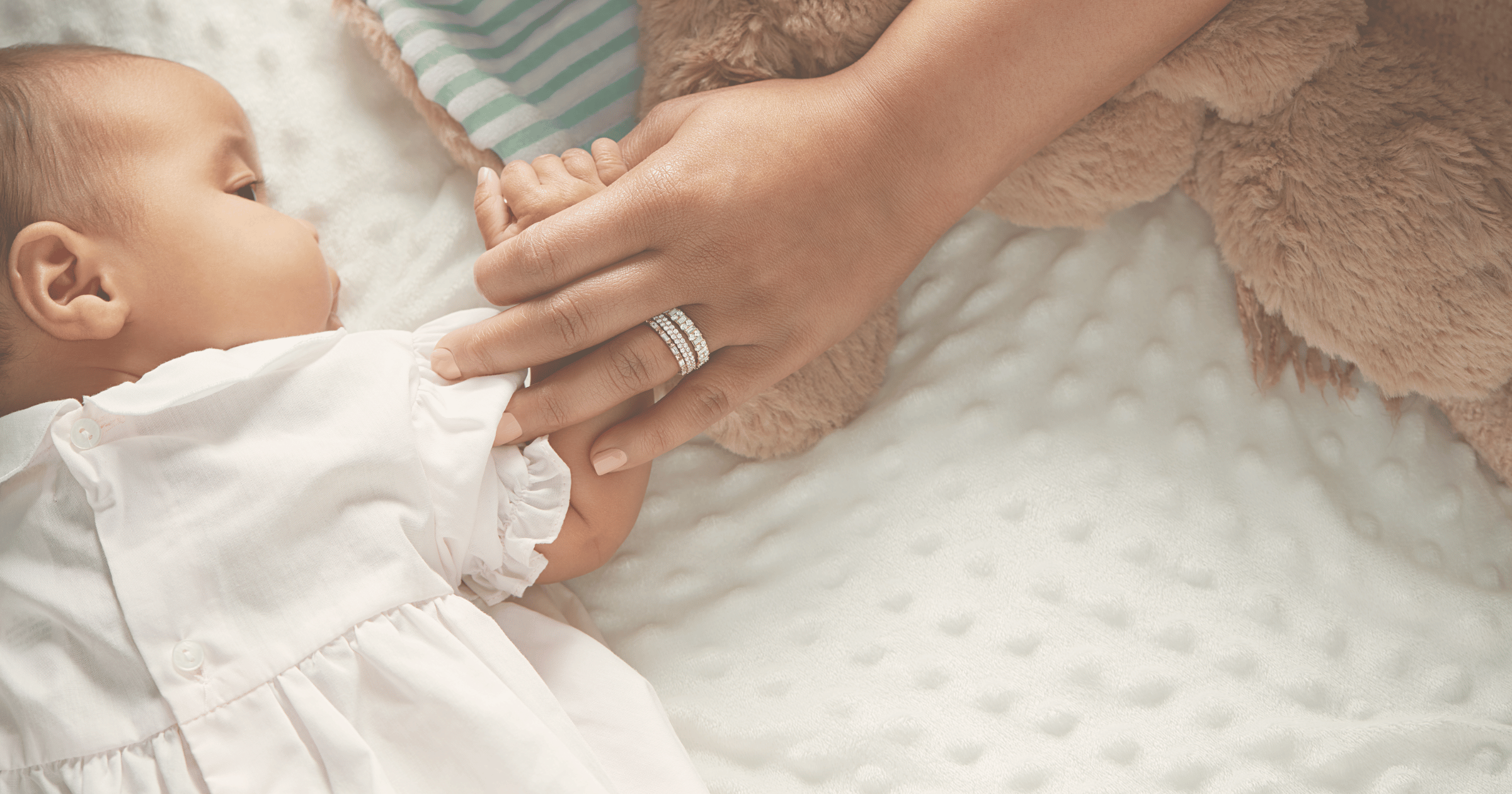 Baby_holding_mothers_hand_showing_push_present_of_diamong_ring_stack