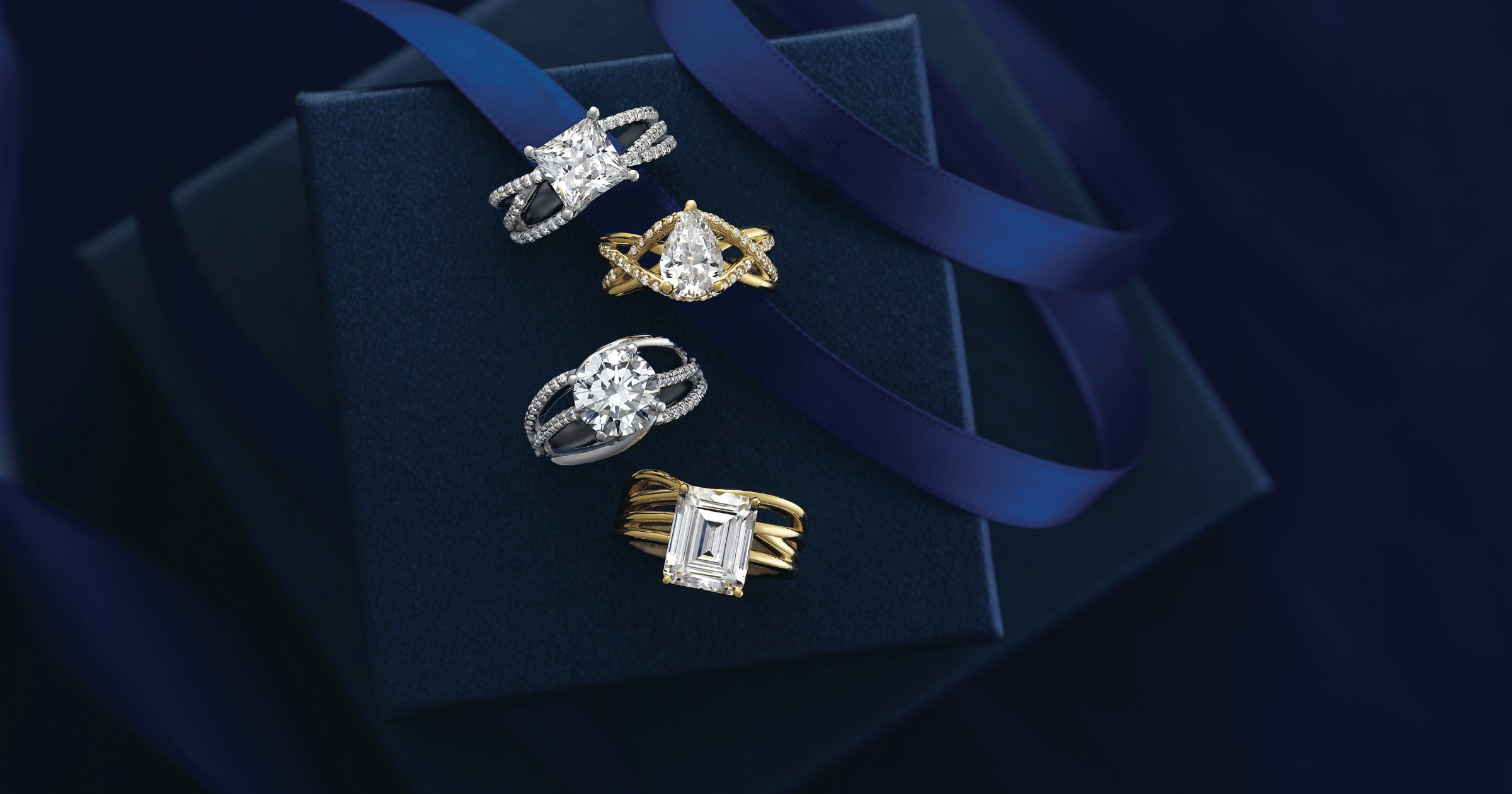 Various_Yellow_Gold_Accented_Engagement_Rings_in_Complimenting_Velvet_Ring_Boxes