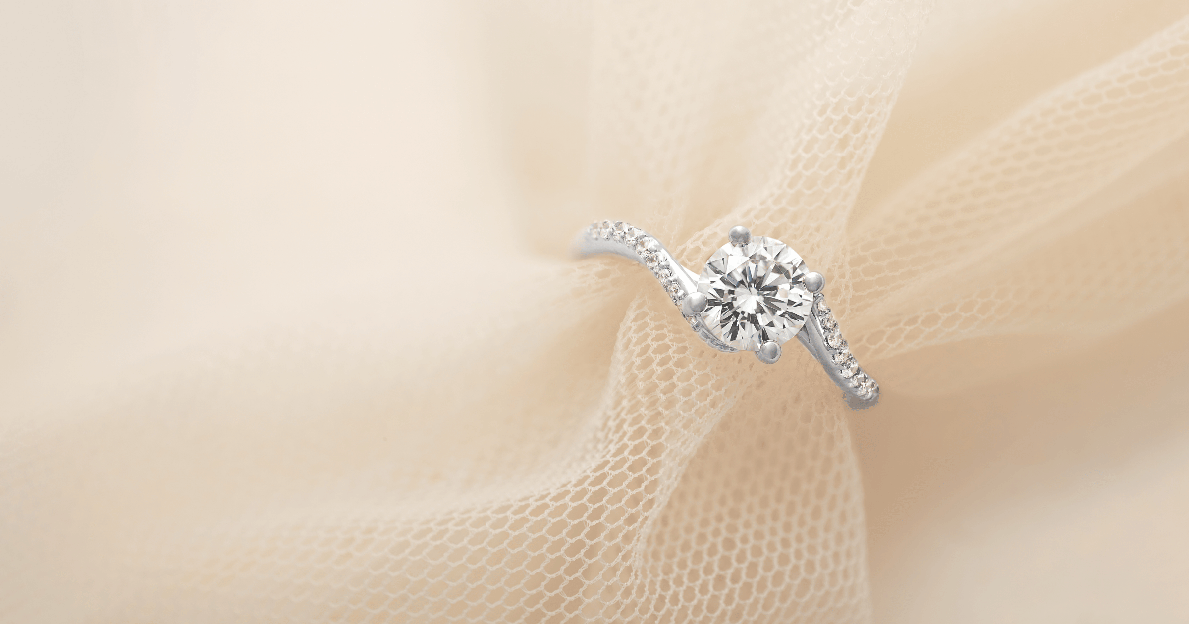 White Gold (or Platinum) Accented Tension Engagement Ring set with a Round Cut Diamond