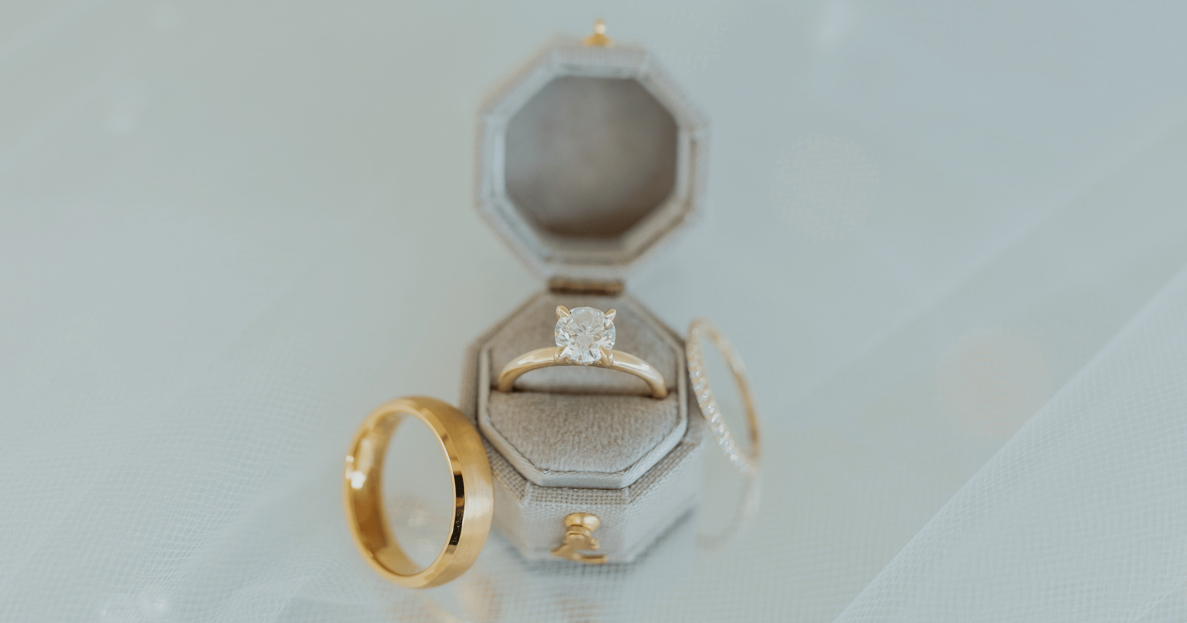 Yellow Gold Solitaire Engagement Ring set with a Round Cut Diamond; Yellow Gold Diamond Accented Wedding Band; Yellow Gold Mens Beveled Edge Wedding Band