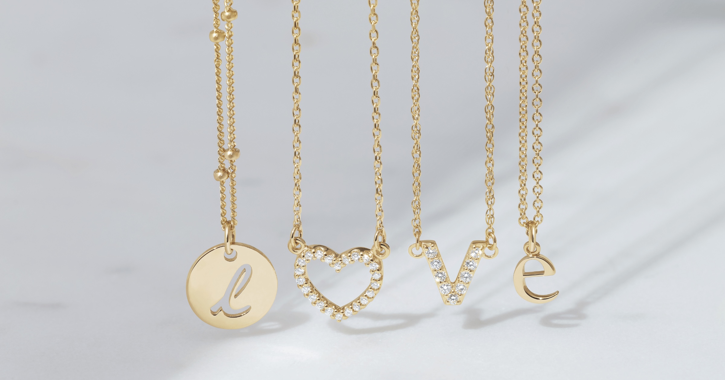 Yellow Gold Necklaces with Letters Spelling LOVE with Diamond Studded Parts