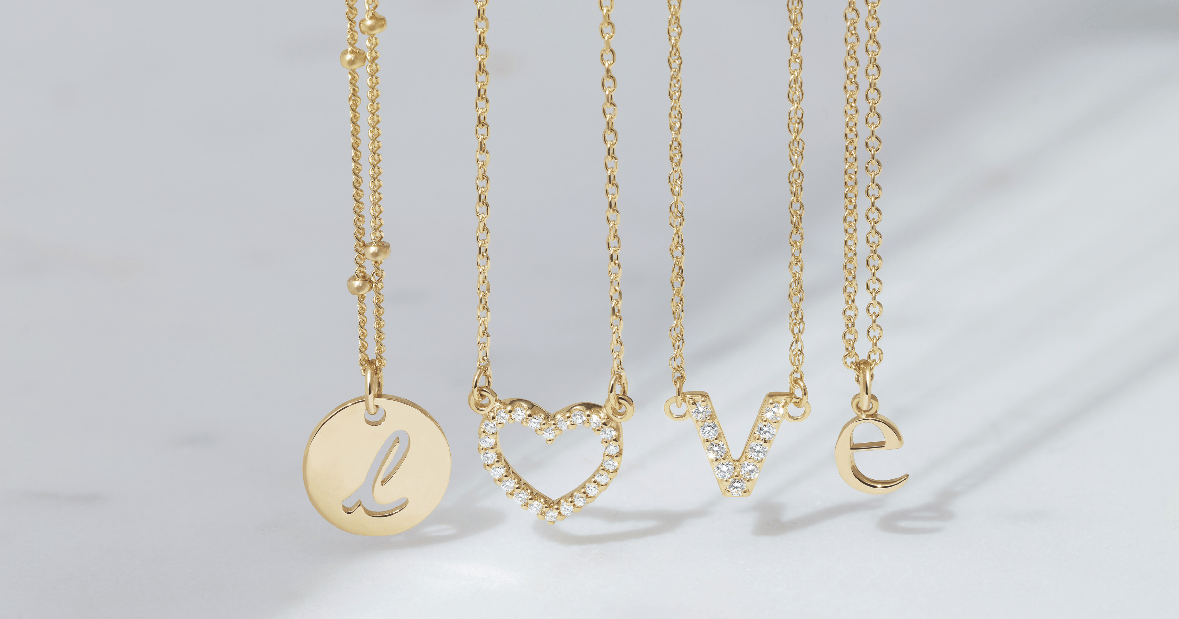 Yellow_Gold_Necklaces_spelling_out_LOVE_using_various_pendants