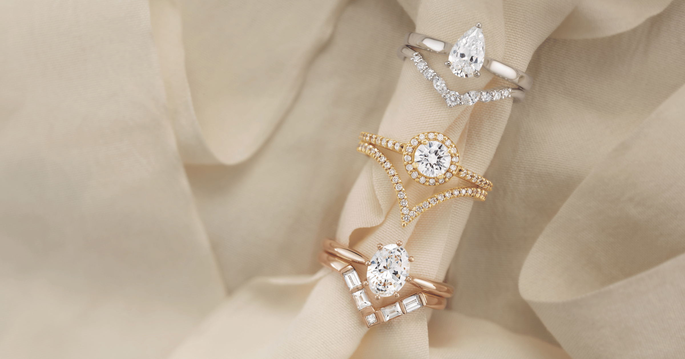 Yellow_Rose_and_White_Gold_(or_Platinum)_Engagement_Rings_set_with_Pear_Round_and_Oval_Cut_Diamonds_and_Matching_Accented_Wedding_Bands